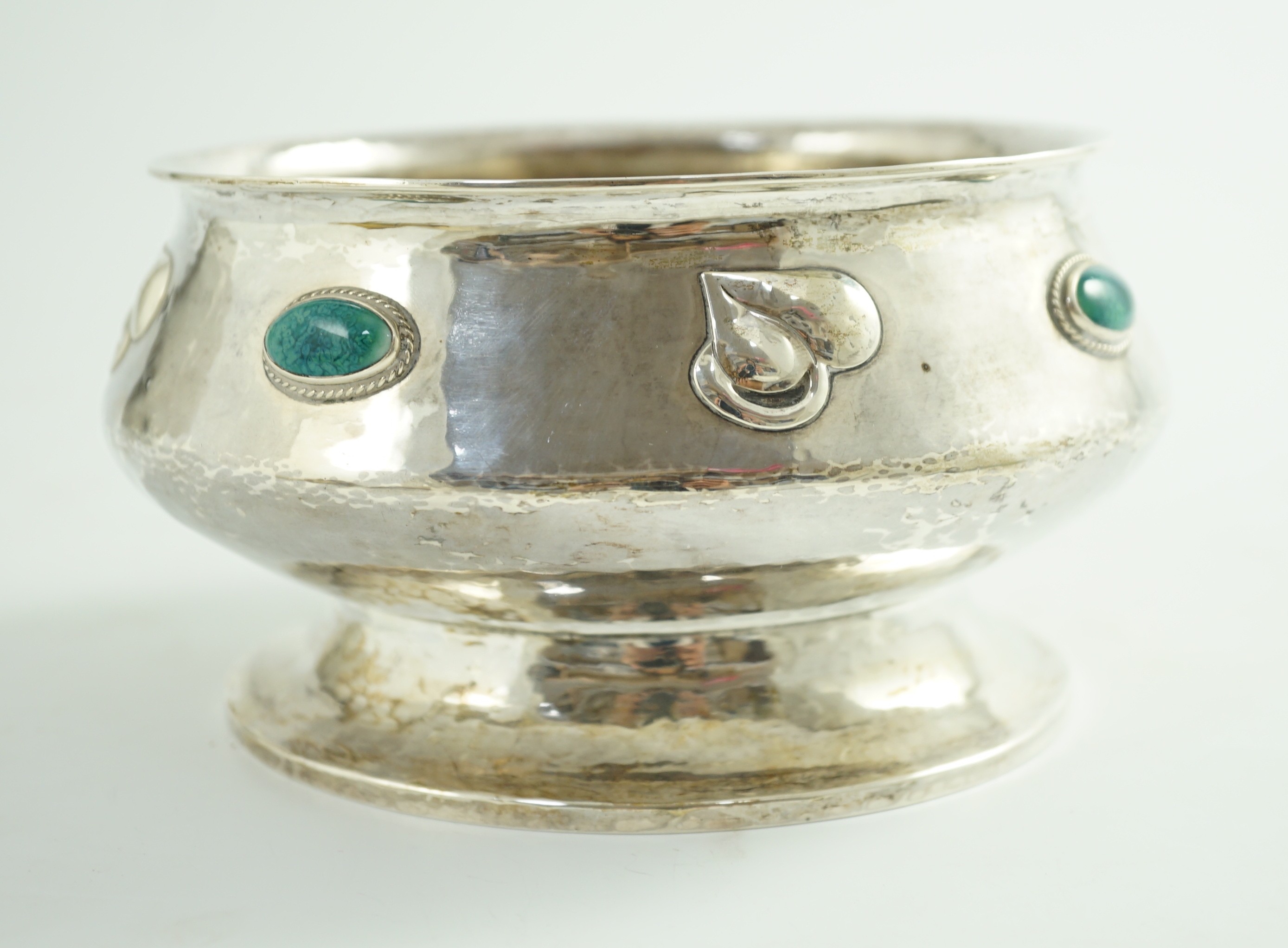 An Edwardian Art Nouveau silver pedestal bowl, inset with four oval Ruskin oval cabochons, by Albert Edward Jones